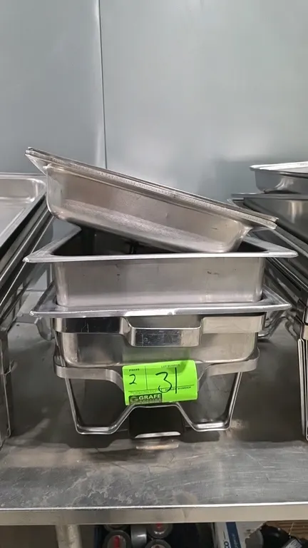 Stainless steel chafing pan sets. Includes lids, pans, and wire stands.