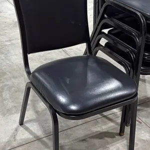 Padded metal frame stacking chair. Features black vinyl upholstered seat and backrest with a black finished metal frame.