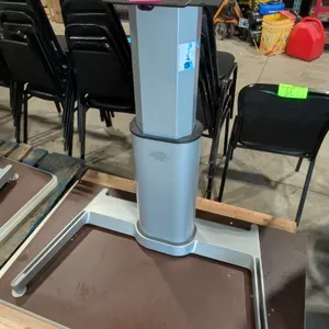 Pneumatic sit-stand desk base with two assorted tabletops. Features an adjustable height center pedestal column and silver-tone metal construction. Mo
