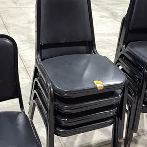 Stacking banquet chairs. Features black vinyl padded seats and backrests with black metal frames. Stackable design. Note: Seat upholstery is torn.