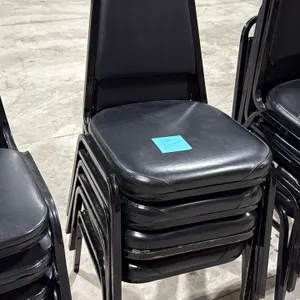 Stackable banquet chair. Features black vinyl upholstered padded seat and backrest with a black metal frame.