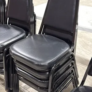 Stackable banquet chairs. Features black vinyl upholstered padded seat and backrest with a black metal frame. Stackable design. Note: Upholstery has v