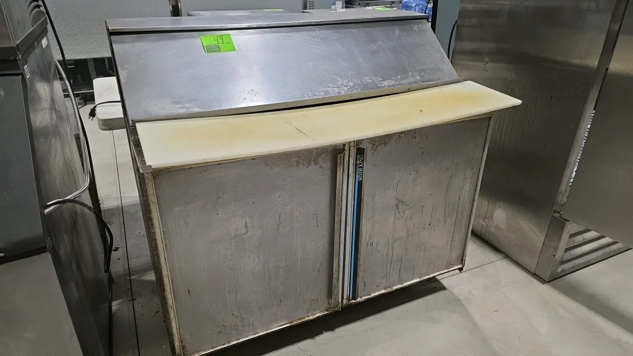 Silver King 2-door refrigerated prep table. Features stainless steel exterior, top pan rail with hinged lid, full-length cutting board, and interior w