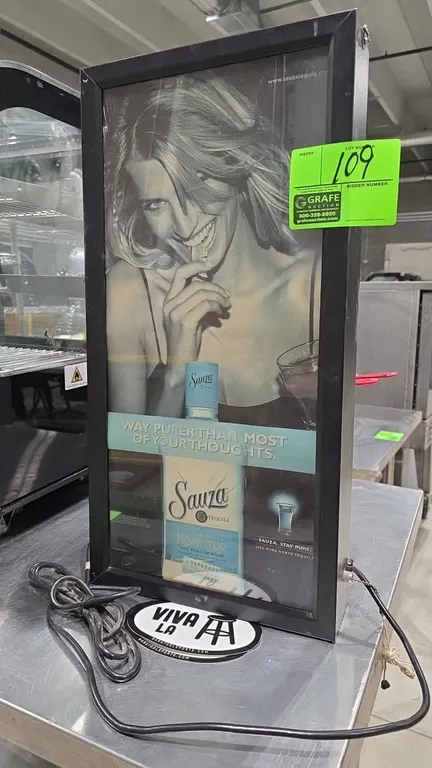 Sauza Tequila Hornitos illuminated advertising light box sign. Features a black metal frame, graphic display panel, side pull-chain switch, and rear m