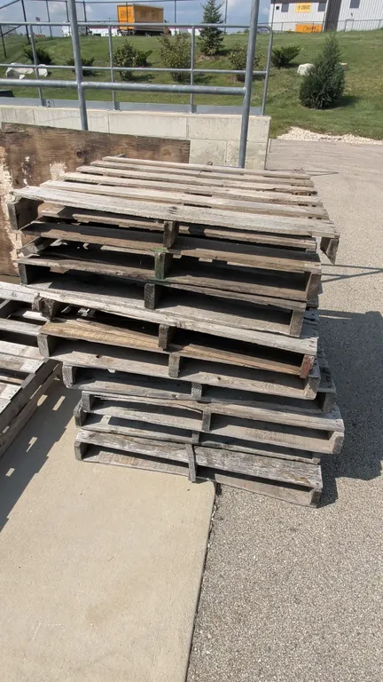 Wooden shipping pallets. Features wood slat construction with forklift entry notches. 40" x 48".