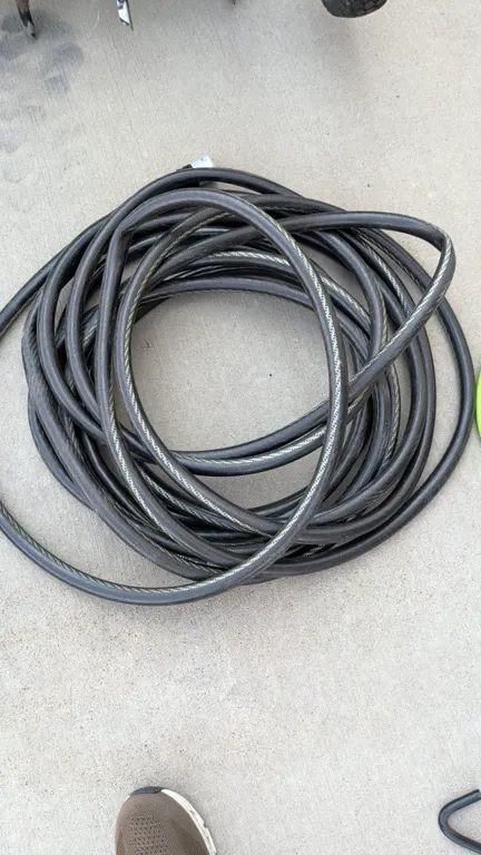 Poly garden hose. Features black reinforced construction. 50'L.