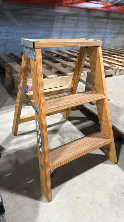Werner W150-4 wood step ladder. Features 2-step folding design with top platform, steel spreader braces, and metal bracket reinforcement. Size: 2'H. D