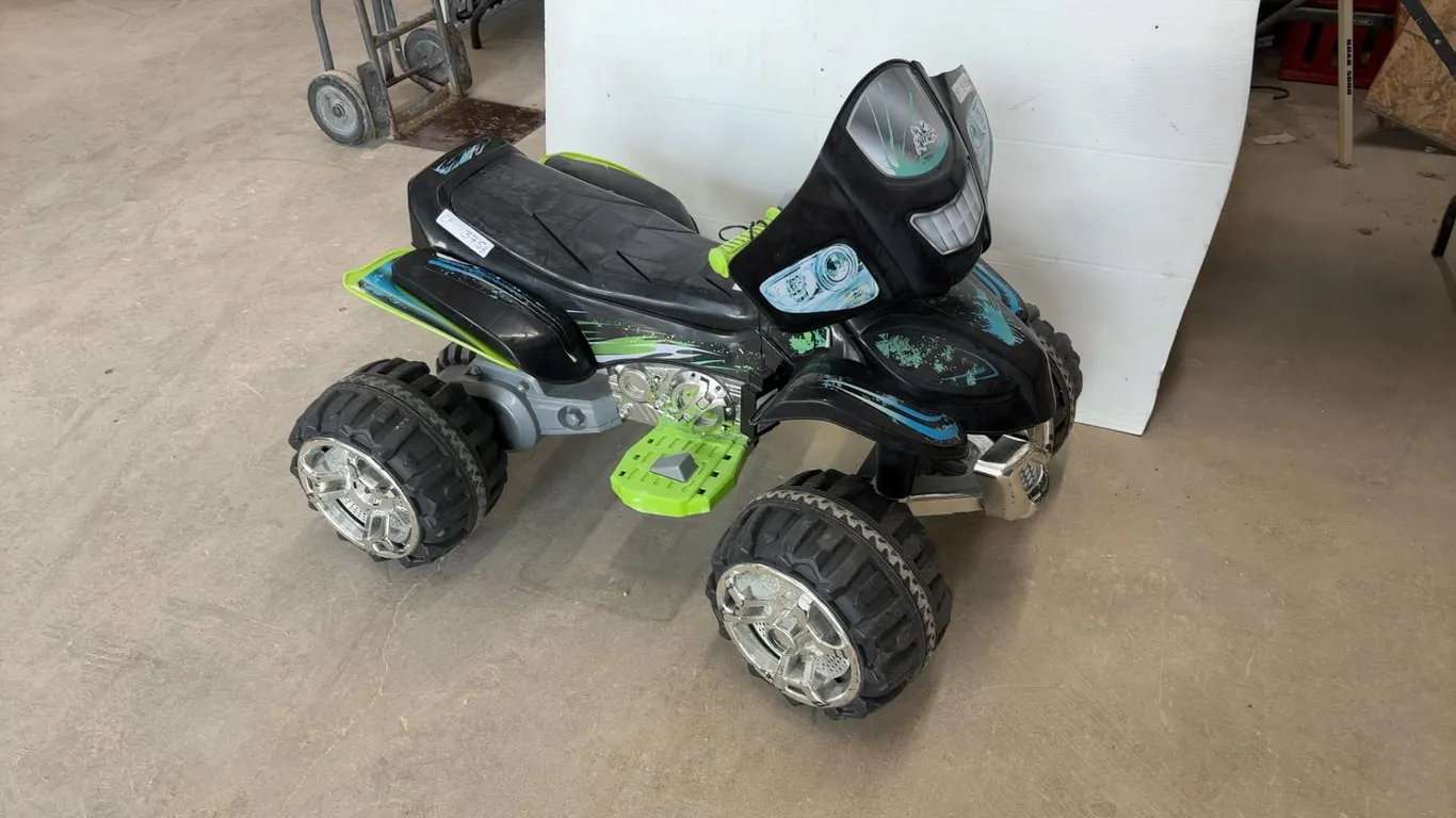 Power Wheels Black and Green ATV Ride-On Toy with Chrome Wheels and Footrests