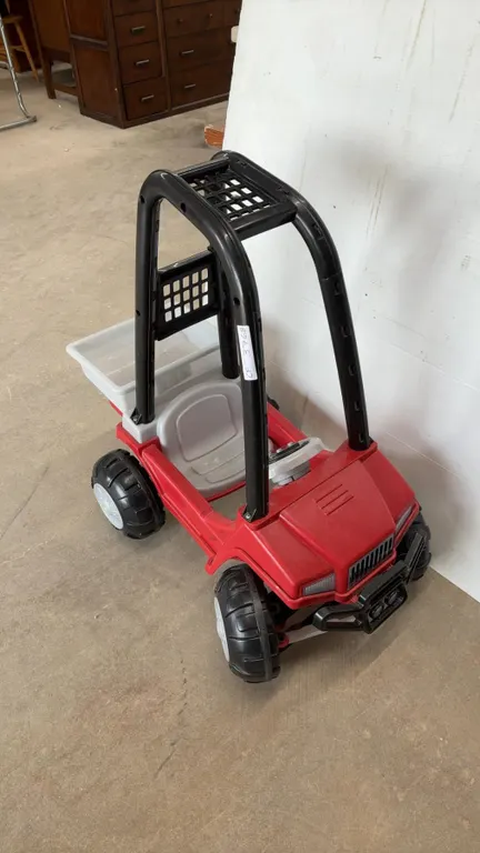 Red and Black Plastic Ride-On Toy UTV with Gray Seat, Steering Wheel, and Rear Dump Bed