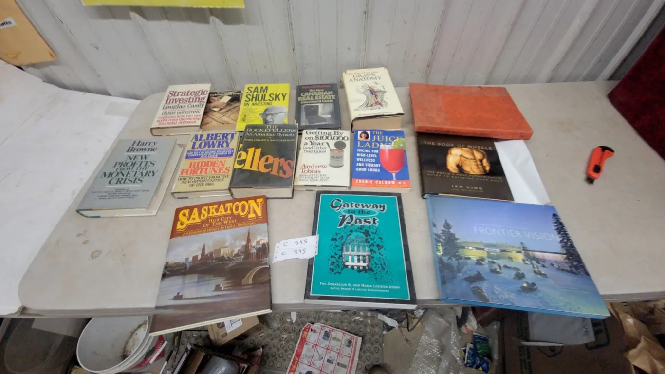 Assorted Books: *Saskatoon Hub City of the West*, *The Book of Muscle*, *Frontier Vision*