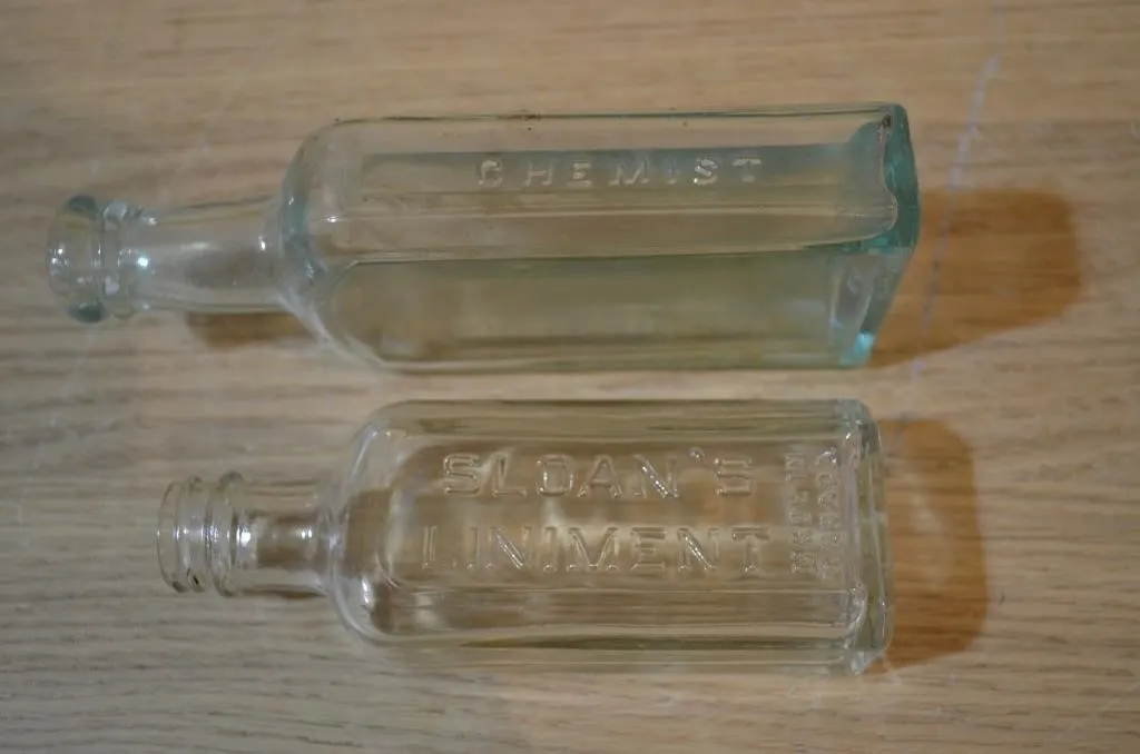 Two vintage embossed glass medicine or chemist