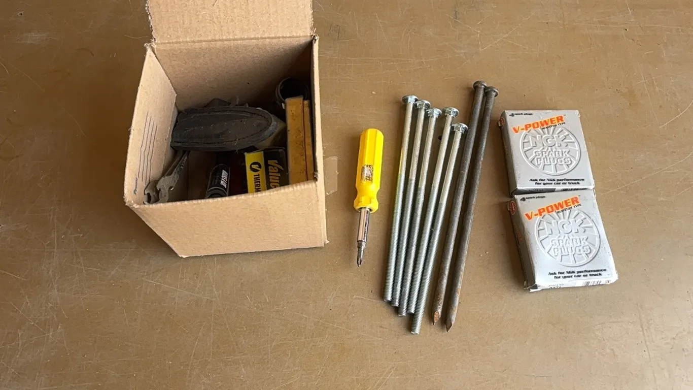 Spark plugs, bolts and nails, screw driver, and misc