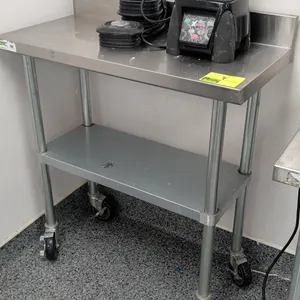 Stainless steel top work table. Features rear backsplash and lower undershelf. 36"W x 18"D. Mounted on heavy-duty casters. Contents not included.
