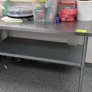 Stainless steel top work table. Features lower undershelf and tubular legs with adjustable bullet feet. 60"L. Contents not included.