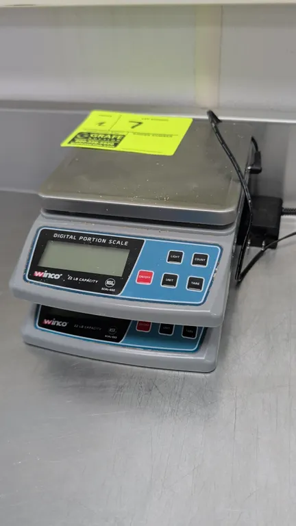 Winco SCAL-D22 digital portion scales. Features 22 lb capacity, stainless steel platform, digital display, and NSF certification. Includes (1) AC powe