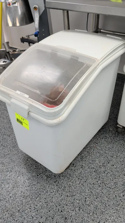 Rubbermaid polyethylene ingredient bin. Features a clear flip-top lid with latch. 18"W. Mounted on casters. Contents not included.