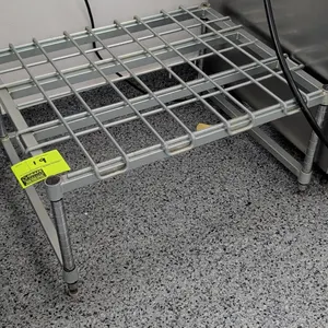 Wire top dunnage rack. Features heavy wire grid surface on tubular frame. Dimensions: 39" x 24". Mounted on four round posts with adjustable leveling 