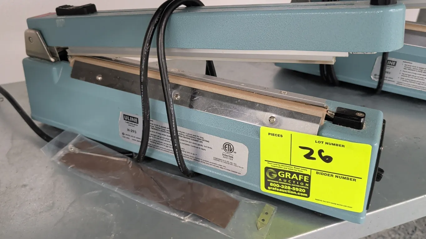 Uline H-293 tabletop impulse bar sealer. Features adjustable timer control knob and manual push-down handle. Includes replacement heating element and