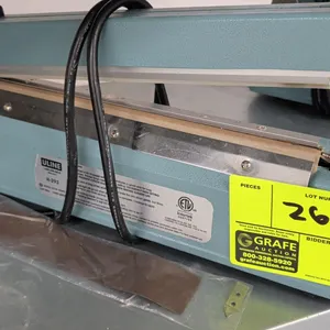 Uline H-293 tabletop impulse bar sealer. Features adjustable timer control knob and manual push-down handle. Includes replacement heating element and 