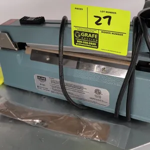 Uline H-161 tabletop impulse sealer with cutter. Features adjustable timer control dial and sliding cut blade. Includes replacement heating element an