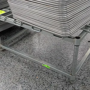 Wire top dunnage rack. Features tubular metal legs, a wire grid top surface, and a 3-sided bottom support frame. 24" x 29". Contents not included.