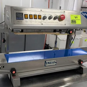 HL-M810 vertical dry ink continuous band sealer. Features stainless steel construction, integrated motorized conveyor belt, digital seal temperature c