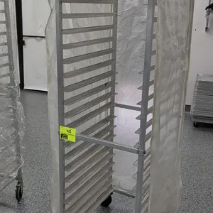 Front load channel sheet pan rack. 20-tray capacity designed for 18" x 26" pans. Features aluminum construction and includes a fitted protective cover