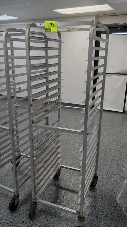 Aluminum front-load sheet pan rack. 20-tray capacity designed for 18" x 26" pans. Mounted on casters.