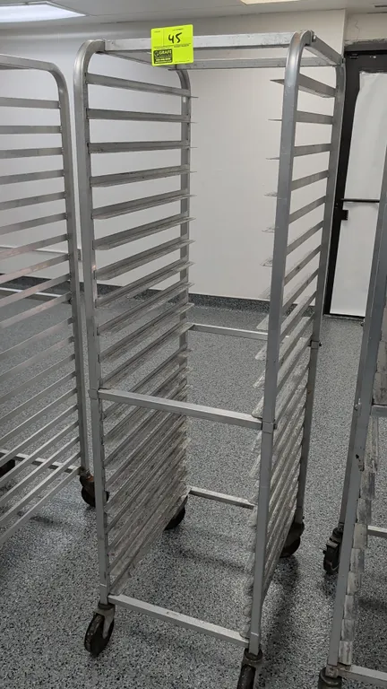 Aluminum 20-pan front-load channel sheet pan rack. Accommodates 18" x 26" pans. Mounted on swivel casters.