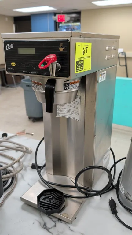 Curtis D500GT12A000 single head commercial coffee brewer. Features stainless steel brew basket, digital controls, and integrated hot water faucet. S/N