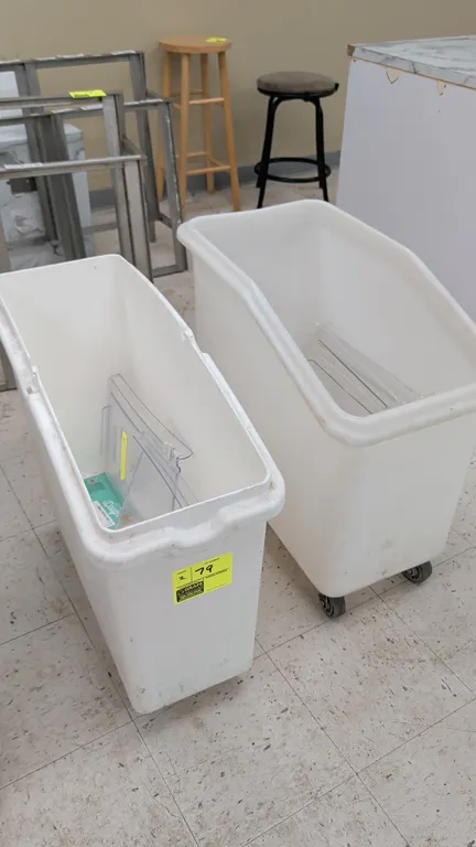 Polyethylene mobile ingredient bins. Features white poly construction and clear plastic covers. Dimensions: 12"W and 15"W. Mounted on casters.