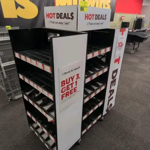 Metal and poly 4-sided mobile merchandise display rack. Features multi-tier wire and tray shelving with product dividers and promotional sign panels. 