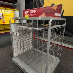 Portable metal merchandise display rack. Features tubular metal frame, vertical wire dividers for boxed or flat merchandise, top display shelf with si