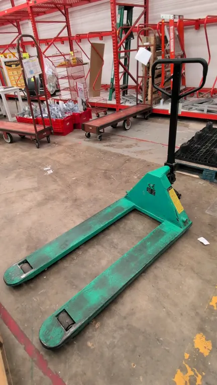 Wesco manual pallet jack. Features a 5,500 lb capacity, 27"W x 48"L forks, looped handle with 3-position hand control release lever, and dual front st
