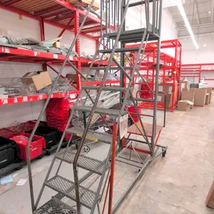 Metal rolling stock ladder with integrated material lift tray. Features expanded metal non-slip steps, safety handrails, and a manual hand-crank cable