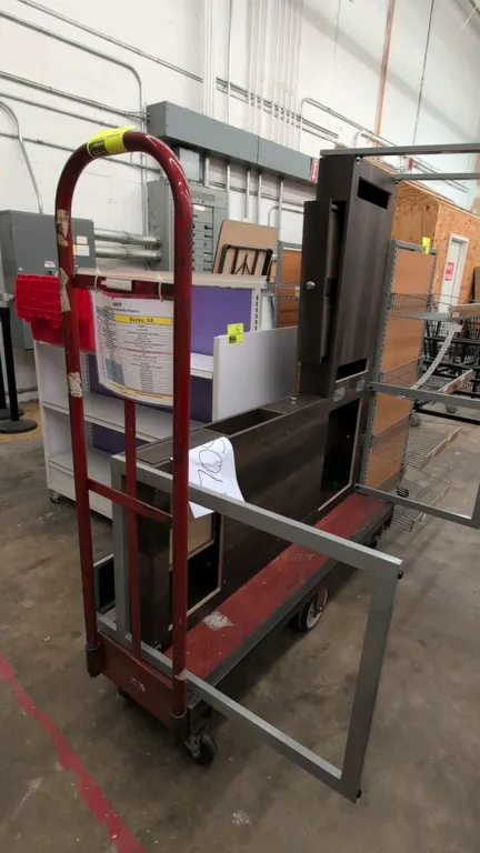 Metal 6-wheel U-boat stocking cart. Features red platform deck and tubular steel end handles. 5'L. Mounted on 6 wheels. Contents not included.