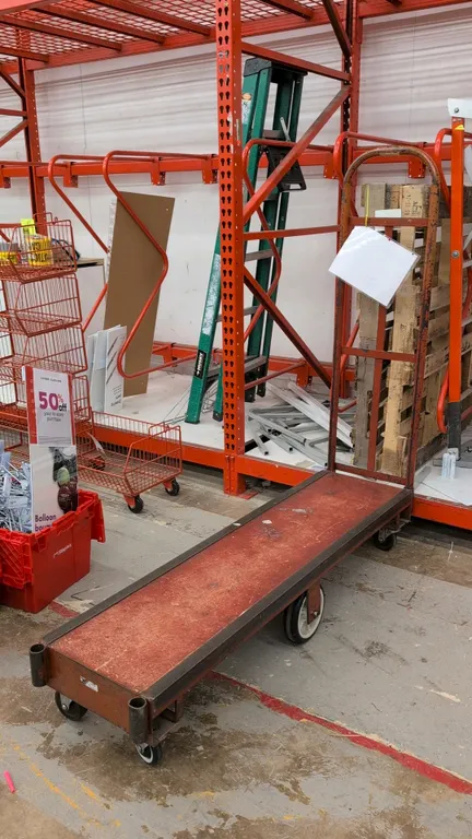 Metal 6-wheel U-boat cart. Features a steel deck and tall tubular end handle. 5'L. Mounted on 6 wheels with center pivot design for maneuverability.