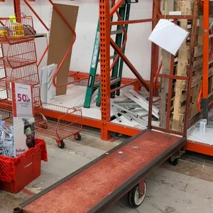 Metal 6-wheel U-boat cart. Features a steel deck and tall tubular end handle. 5'L. Mounted on 6 wheels with center pivot design for maneuverability.