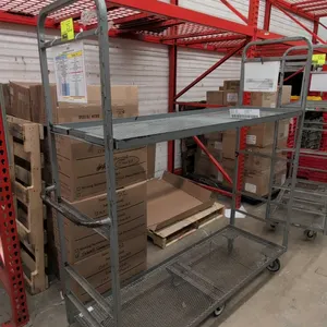 Metal 2-tier U-boat platform cart. Features expanded metal mesh shelves, tubular steel end frames, and integrated push handles. 5'L. Mounted on a 6-wh