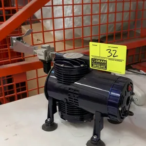 Fengda AS-08 air compressor. Features 1/3 HP motor, 50 PSI max pressure, 135 L/min air flow, and attached pressure regulator with lever assembly. Dime