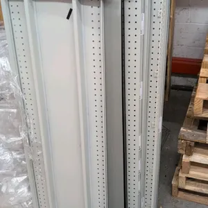 Quantity of assorted metal gondola shelving components. Includes various metal shelves, brackets, and accessories in assorted sizes. Painted steel fin