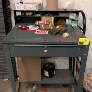 Edsal metal shop desk. Features upper organizer compartments, single pull-out drawer, and lower storage shelf. Dimensions: 34"W x 53"H. Gray painted s