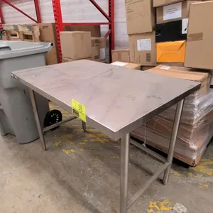 2015 Winholt DTR-3048 stainless steel prep table. Features a flat top and open base with 3-sided tubular cross bracing. 4' x 2.5'. Mounted on stainles