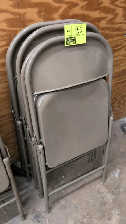 Metal folding chairs. Features beige painted steel construction, contoured seat and backrest, tubular metal frame, and folding design.