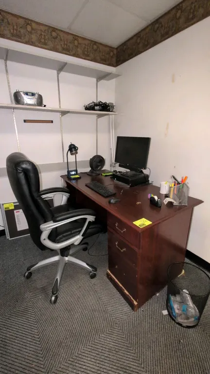 Wood desk with Sealy Posturepedic faux leather office chair. Double pedestal desk features cherry finish and drawers. Chair features high-back black f