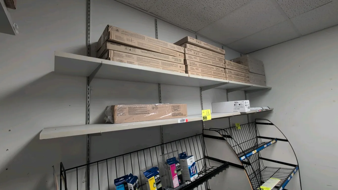 8'L 2-tier wall-mounted shelving unit. Features adjustable vertical wall standards, mounting brackets, and wood shelves. Contents and lower display ra