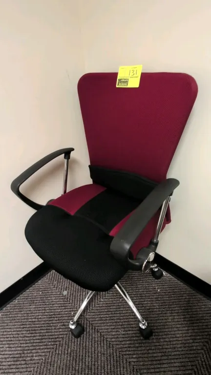 Mesh swivel office chair. Features burgundy and black mesh fabric upholstery, attached lumbar support cushion, armrests, and pneumatic height adjustme