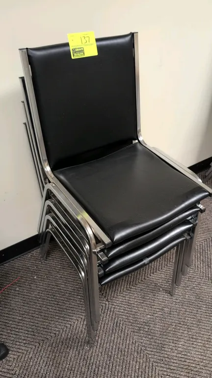 Faux leather stacking chairs. Features black cushioned upholstery on seat and backrest with a chrome metal frame and stackable design.