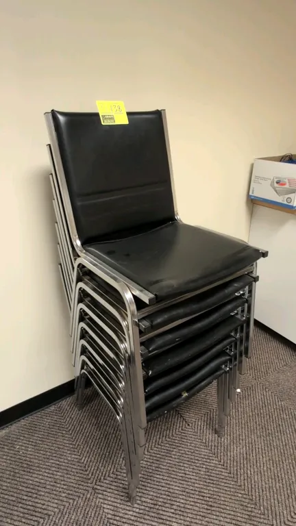Faux leather stacking chairs. Features black faux leather upholstered seats and backrests. Chrome-finished metal frames with stackable 4-leg design.