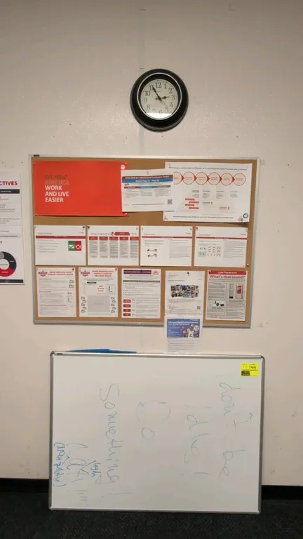 Office board and clock lot. Includes (1) 3' x 4' metal-framed cork bulletin board, (1) 3' x 4' metal-framed dry erase whiteboard, and (1) 12" Waltham